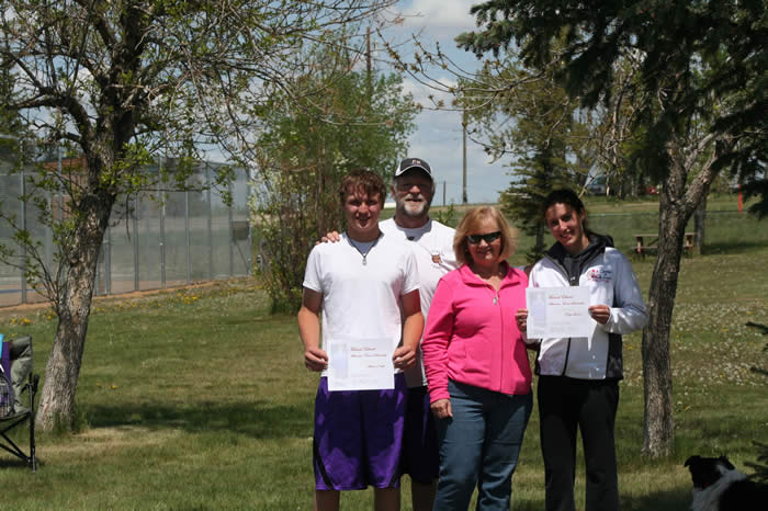 Picture of Co-recipients of the Michael Elhard Scholarship - Michael Kraft - Paige Larsen with Laurie & Coach Gregg